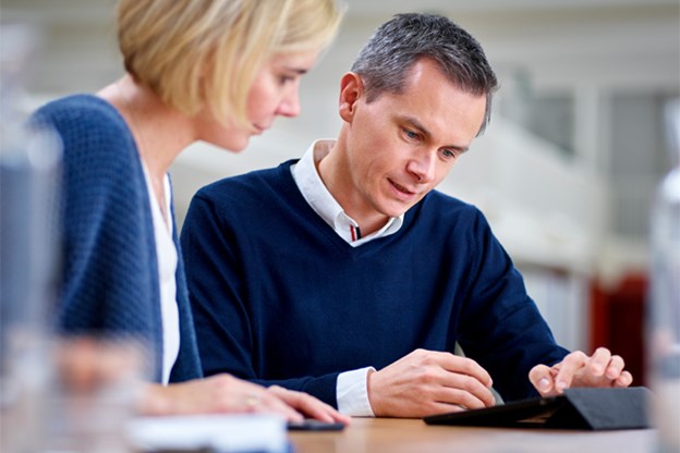 Man and Woman looking at tablet together